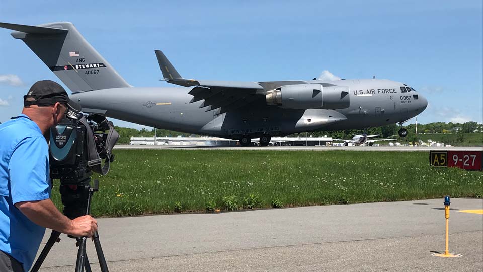 Cameraman with Air Force aircraft on the runway